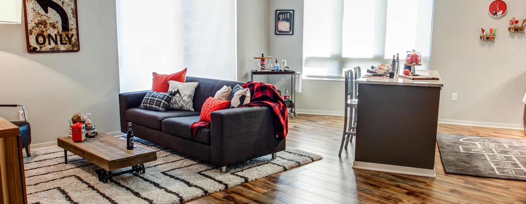 Furnished living room and dining space with large windows at The Paxon Minneapolis apartments