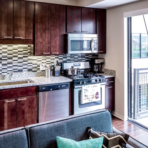 Beautiful kitchens with designer finishes open kitchen next to sliding door access to private balcony