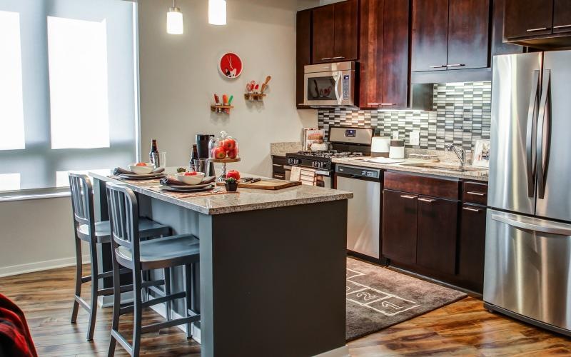 Open, upscale kitchen with island at The Paxon pet-friendly apartments in Minneapolis