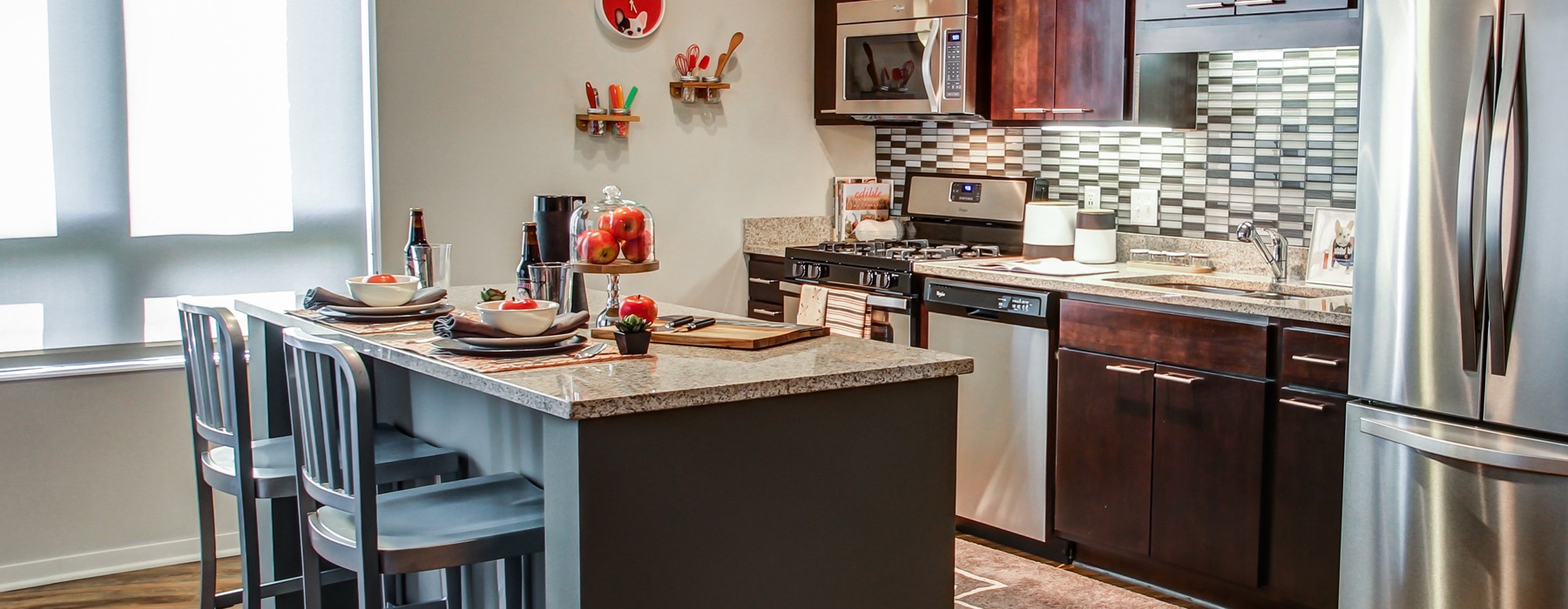 Open, upscale kitchen with island at The Paxon pet-friendly apartments in Minneapolis