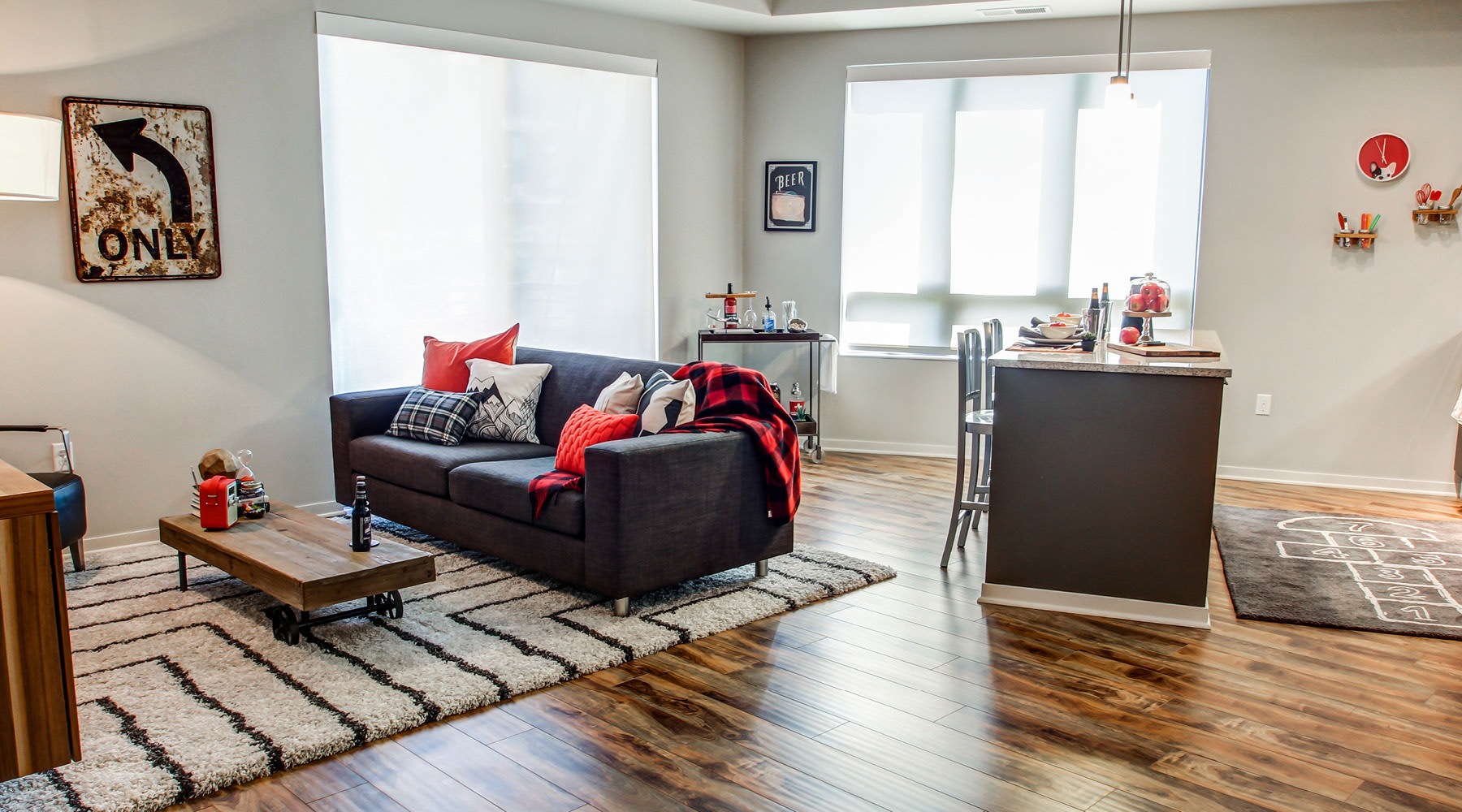 Urban Living in North Loop Furnished living room and dining space with large windows at The Paxon Minneapolis apartments