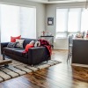 Furnished living room and dining space with large windows at The Paxon Minneapolis apartments